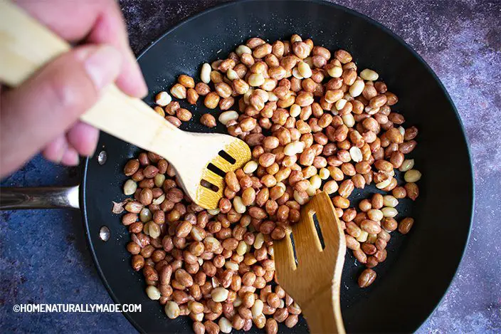toss and cover peanuts in the fry pan with a minimal amount of oil