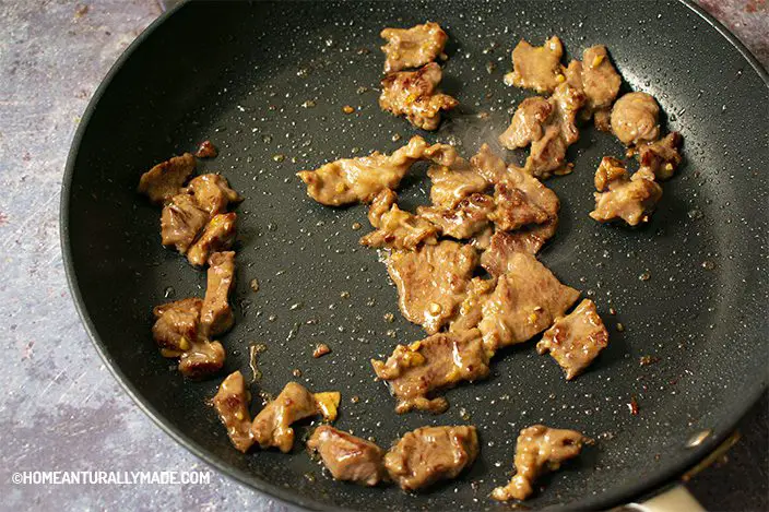 Sear marinated beef slices in small batch in a hard anodized fry pan