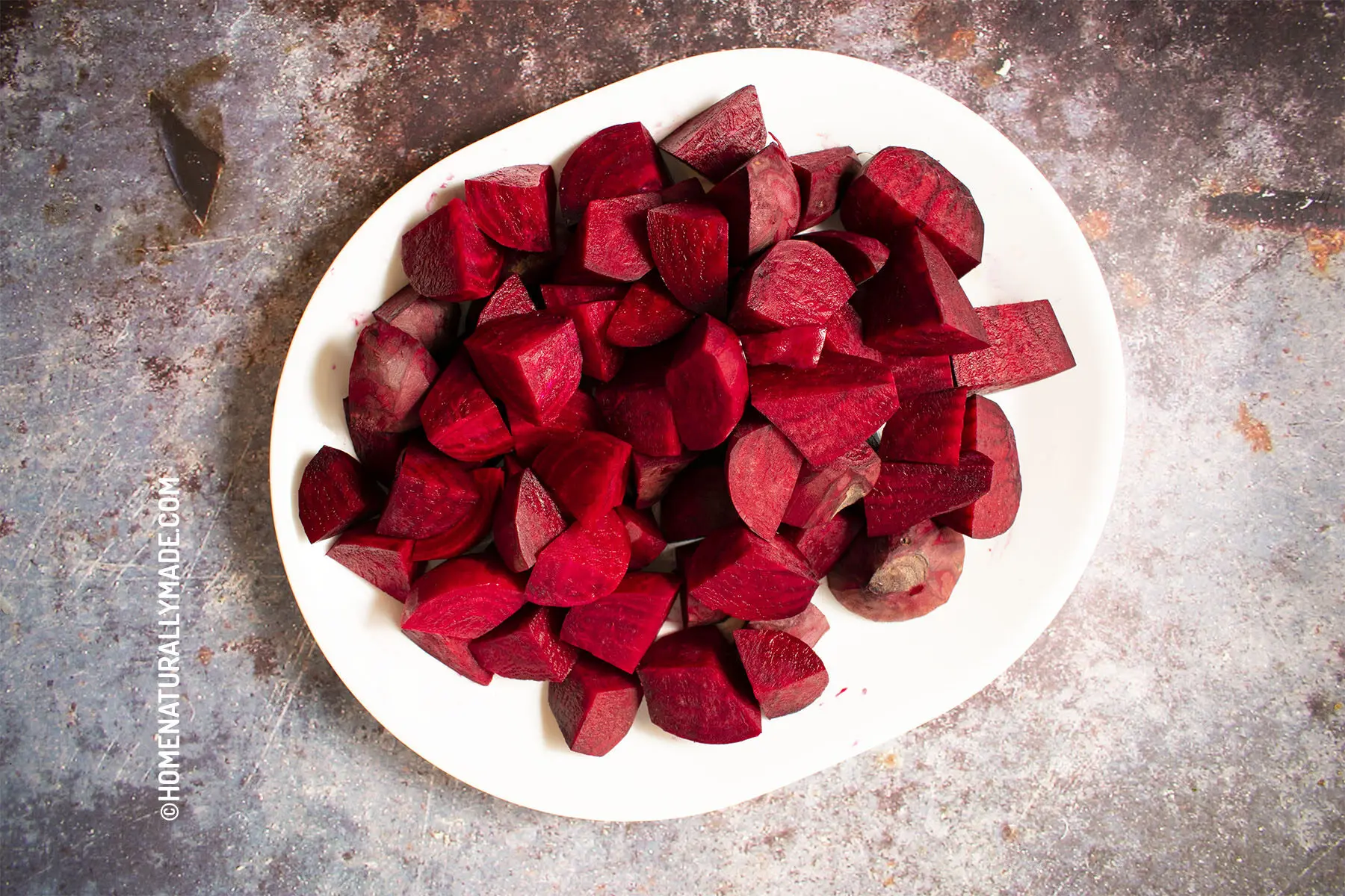 Cut peeled beet into optimal size and shape for the juicer