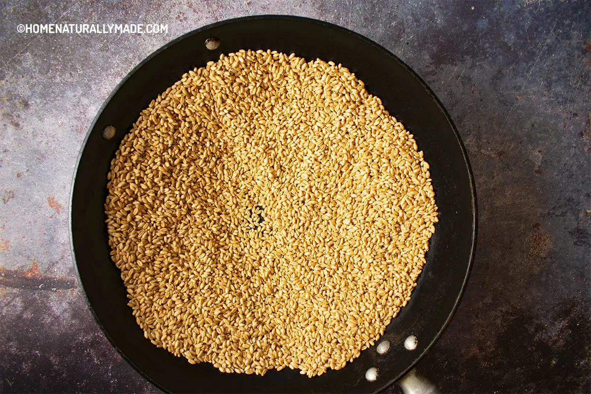 Spread grains in thin layers in the wok to roast at low heat