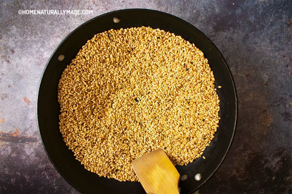 Roast grains in the wok in a thin layer via stovetop