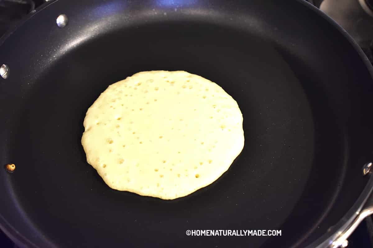 Drop pancake batter on heated fry pan to make pancakes