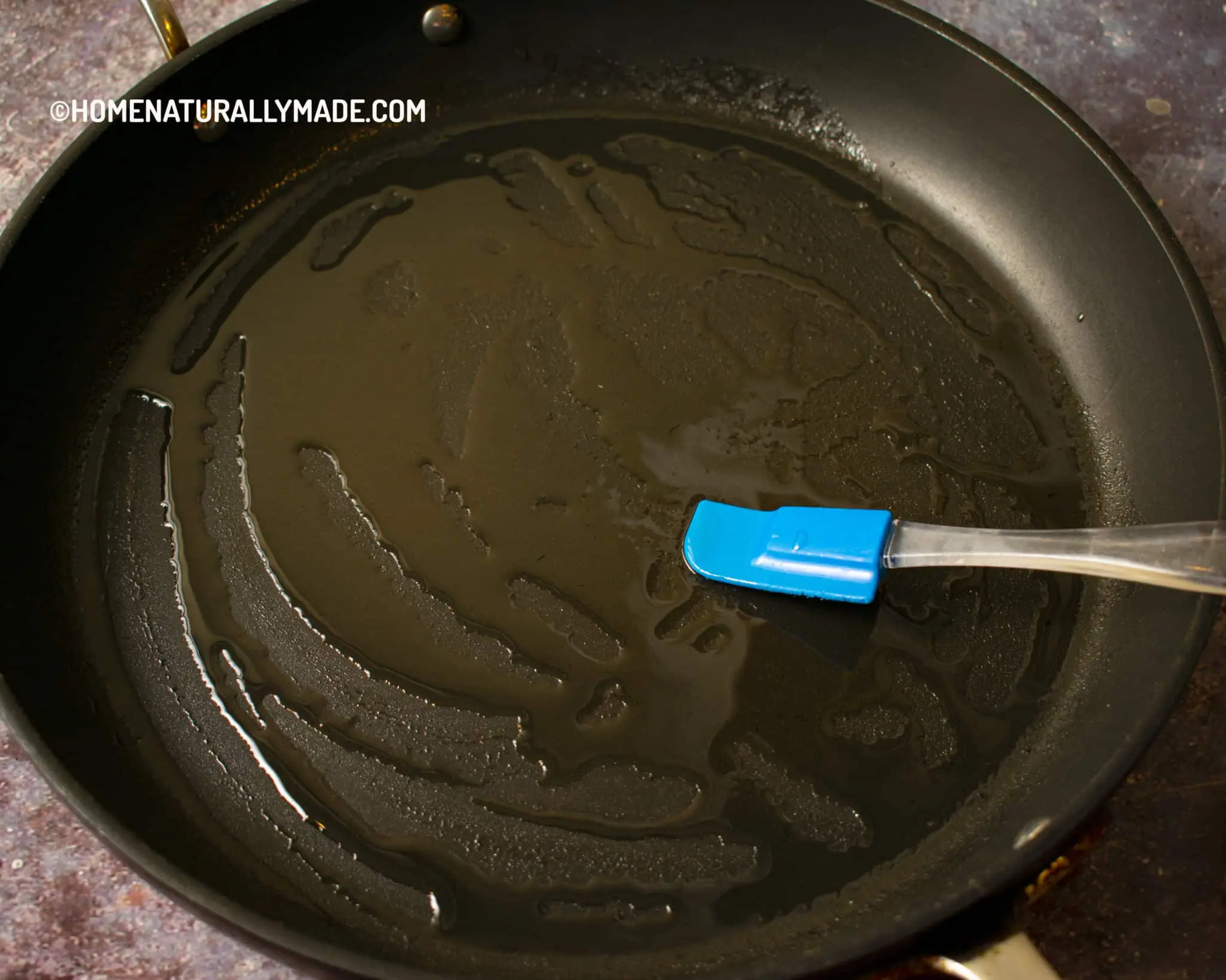 Use a mini spatula to spread the oil evenly across the pan