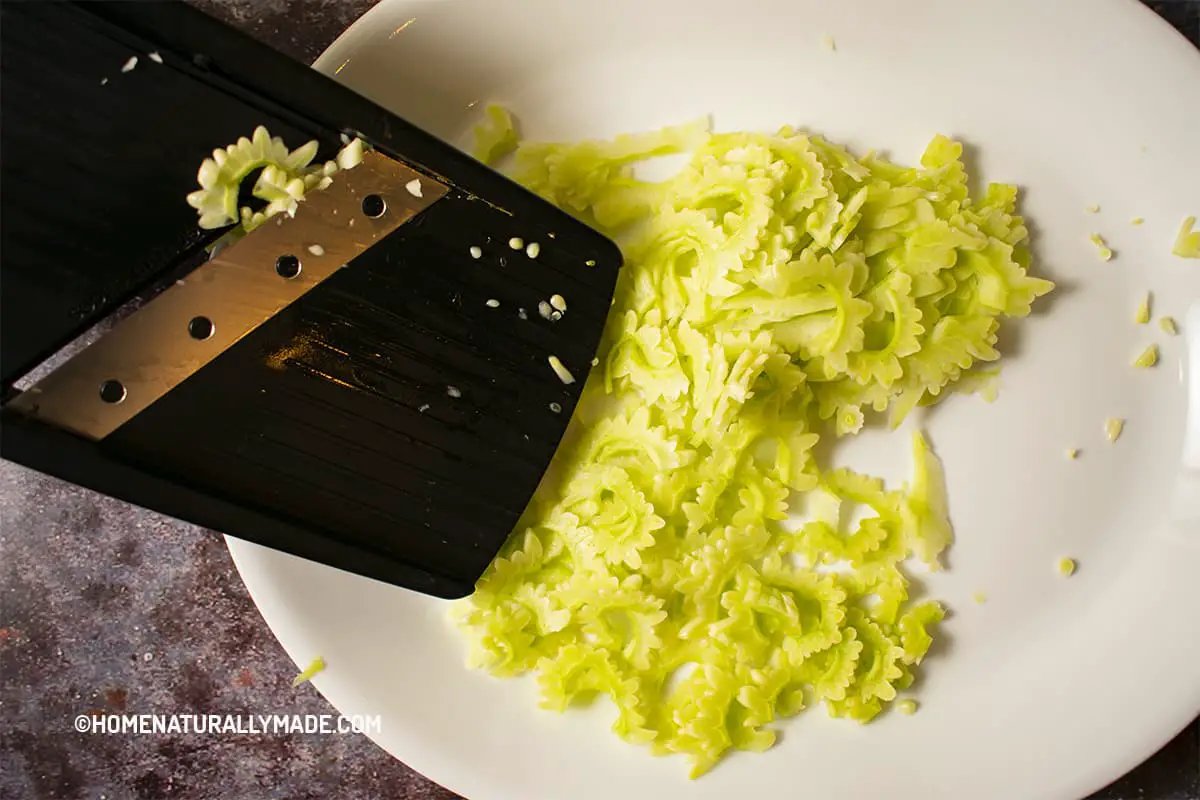 Cut Bitter Melon into thin slices using a Mandoline Slicer