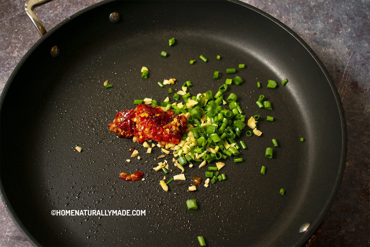 minced ginger, chopped green onion, Duo Jiao and Pi'Xian DouBanJiang in the fry pan