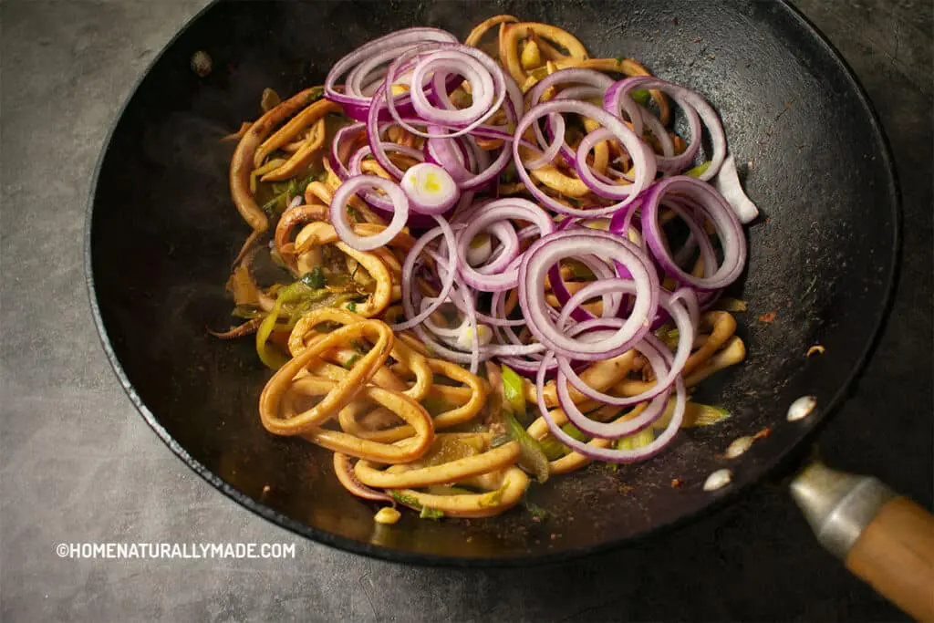 stir fry squid with celery and red onion in the wok