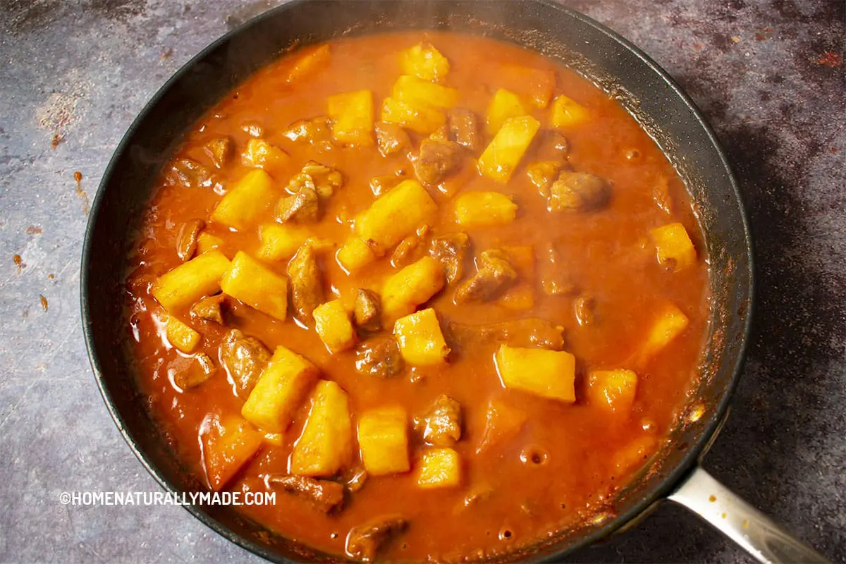 freshly cooked sweet and sour pork with pineapple in the pan