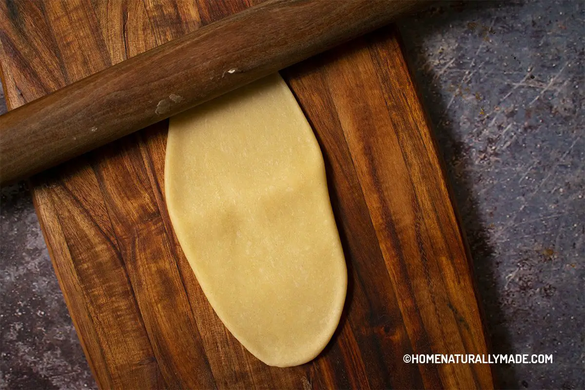 Roll the water-based and oil-based dough disk into a long stripe for Chinese flaky pastry wrappers