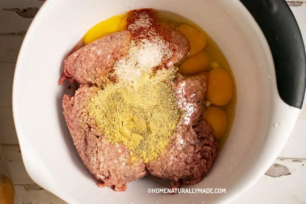 Marinate ground beef for burger meat with homemade seasoning and eggs