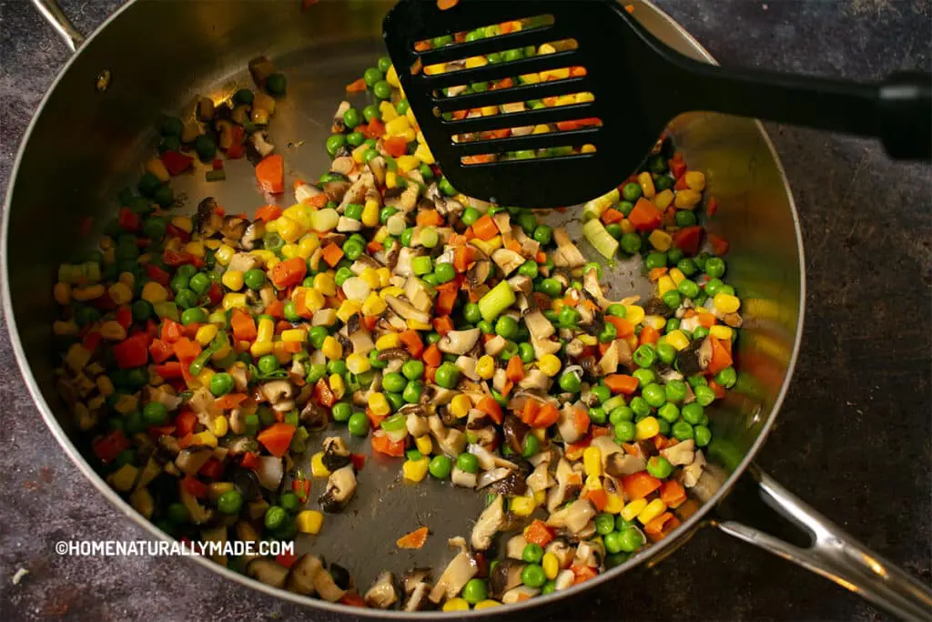 Stir Fry shiitake, corns, peas and carrots in the pan