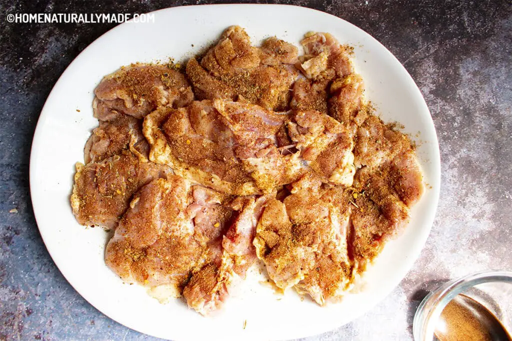 apply homemade Roti Chicken Dry Rub on chicken thighs