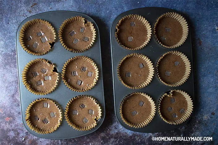 chocolate muffin batter in the baking cups