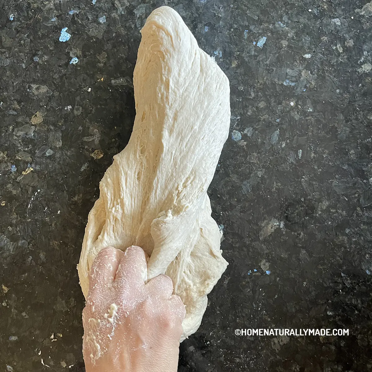 slap the dough against hard surface for making bread
