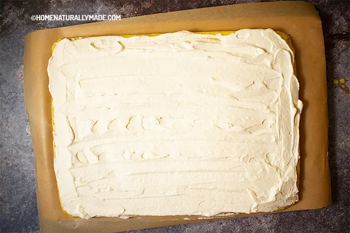 apply a layer of whipped cream over the sponge cake sheet