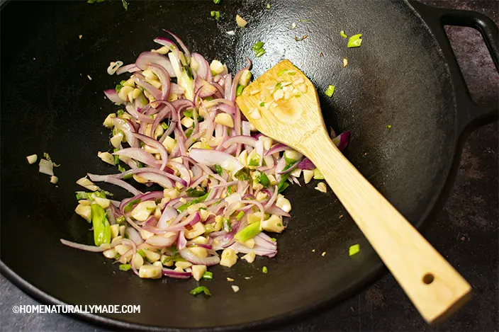 sautee garlic, green onion and red onion in the cast iron wok