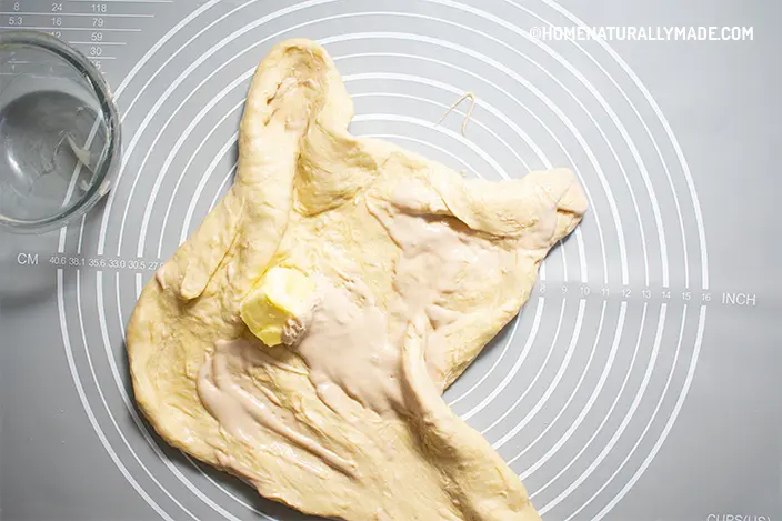 place the softened butter and active dry yeast paste on a stretchy dough
