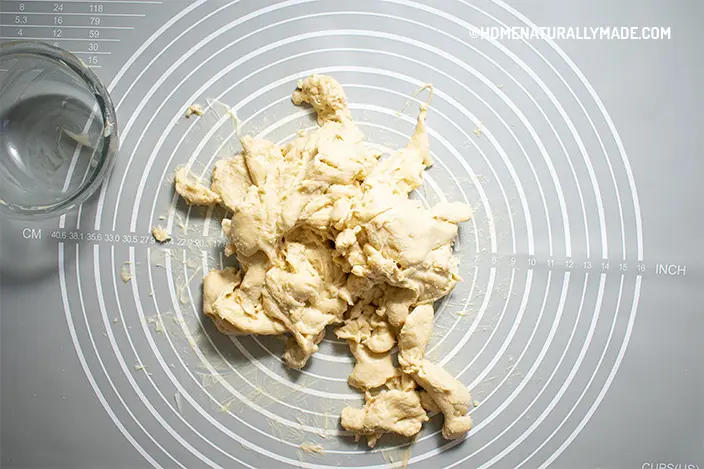 Pull dough apart and then knead together