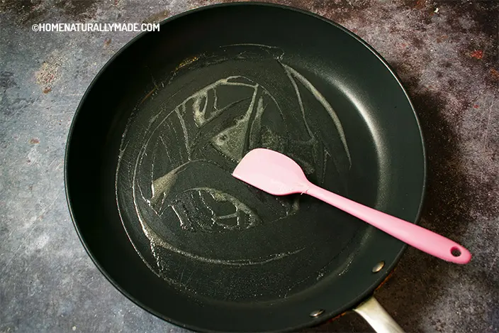 add a tiny bit of butter to a heated hard anodized fry pan