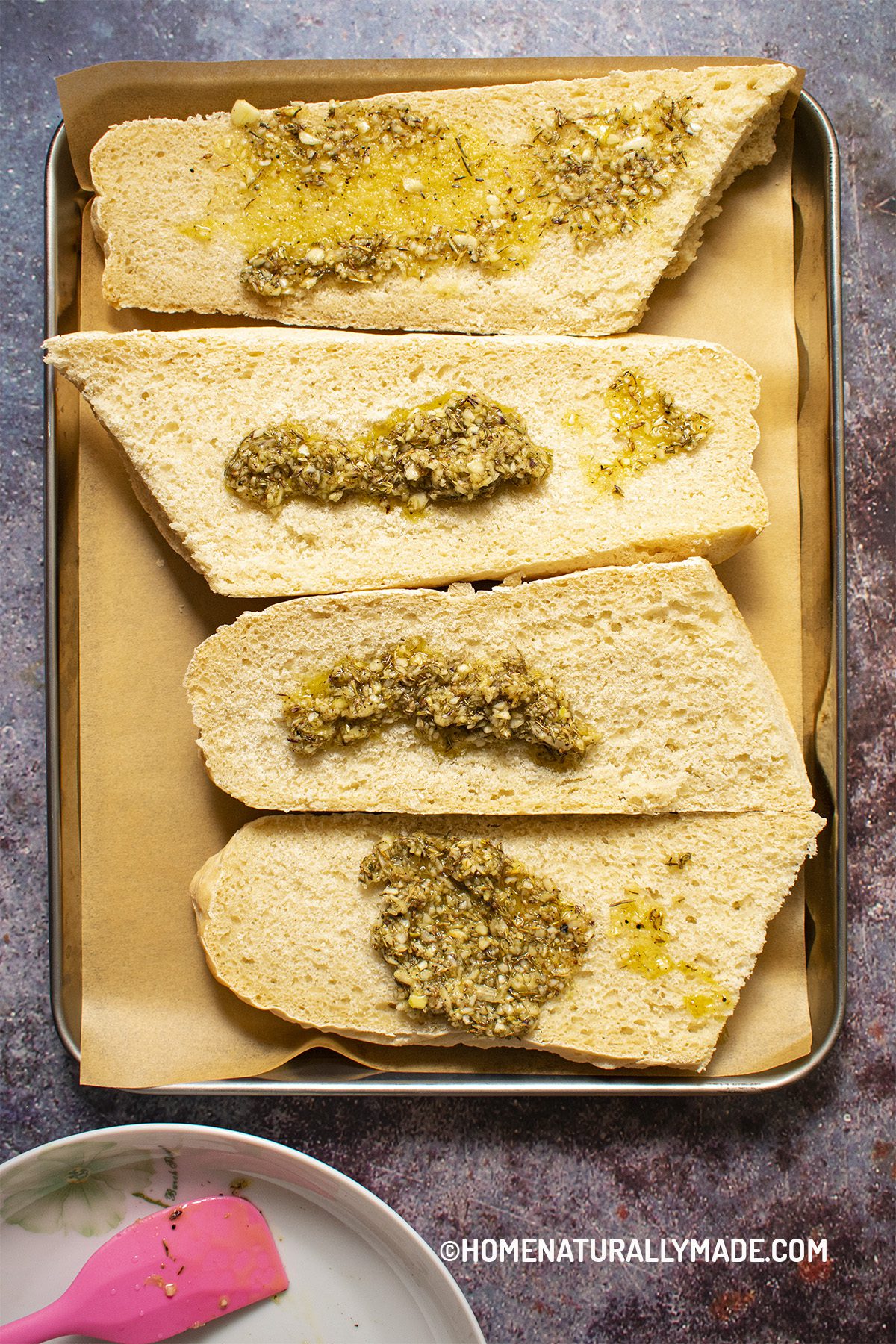 garlic bread spread on french bread slices
