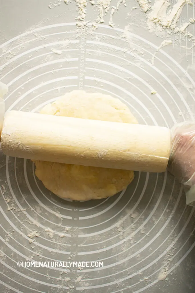 roll out the pie crust on the large dough mat