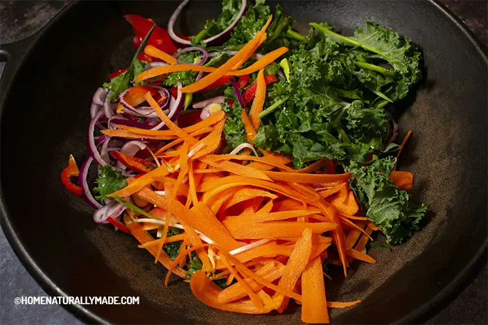 stir fry vegetables in the wok for vegan chow mein