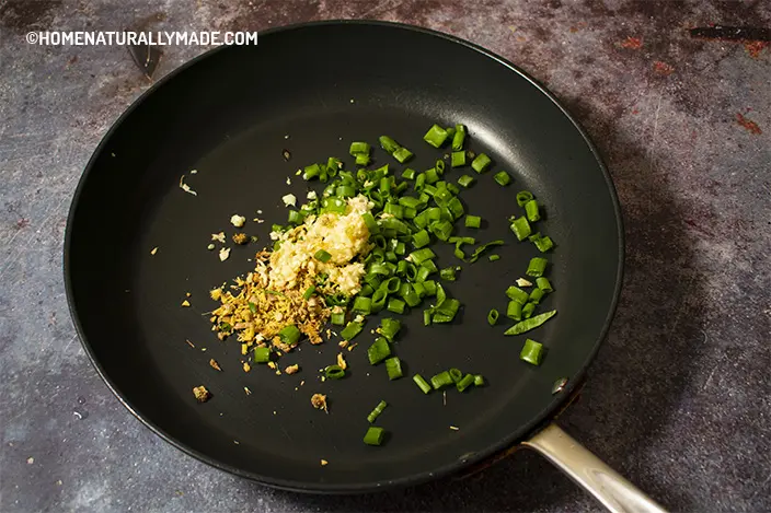 stir fry green onion, garlic and ginger in a frying pan until fragrant