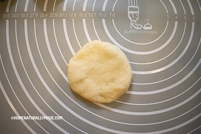 for each bun portion of dough, press and organize into a round disk