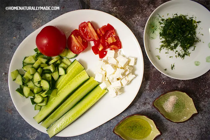 chop cucumber and tomato for Greek Salad