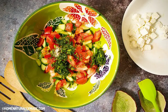 add cucumber, tomato cubes to a mixing bowl along with chopped dill, salt and olive oil