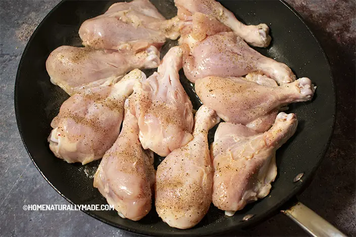add seasoned chicken drumsticks to the frying pan