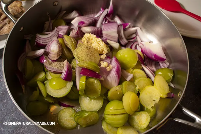 Stir fry tomatillo slices, red onion and minced garlic with salt and black pepper