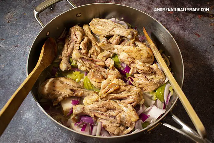 browned chicken, tomatillo and red onion in the sauce pan