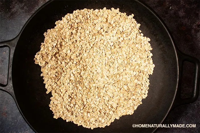 roast rolled oats in cast iron wok stovetop