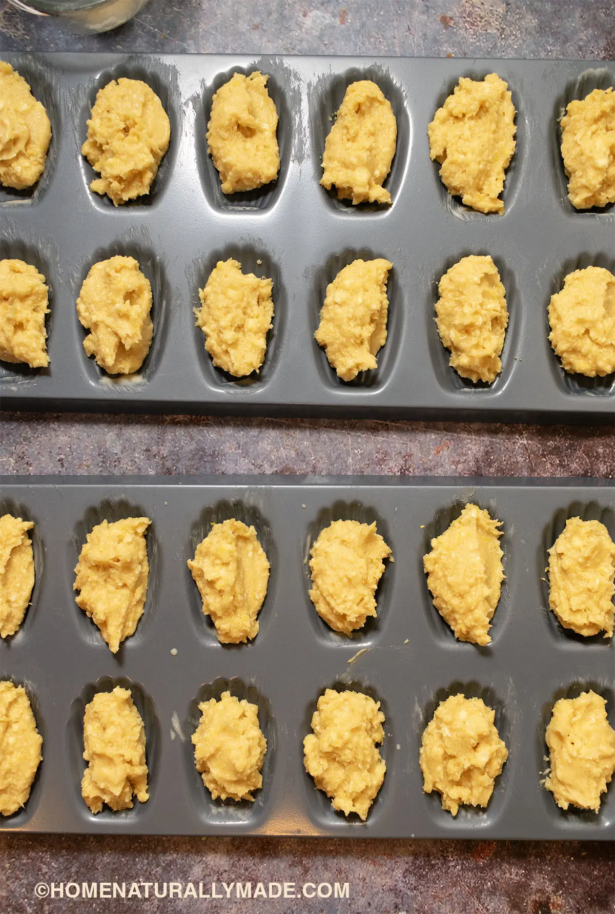 add homemade Madeleine batter to the baking pan