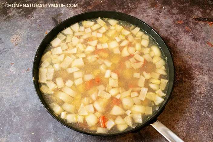 add the chicken broth to the pan fried vegetable assortment and cook