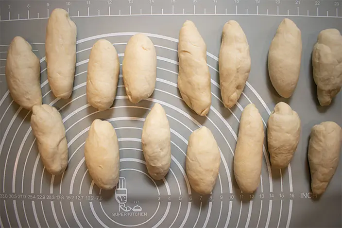 divide the dough and knead each portion into a spindle shape for making Chinese Burger Bun