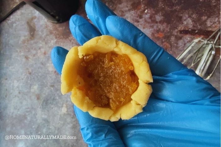 add pineapple filling to center of the feng li su wrapper