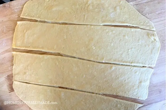 roll out pastry dough and cut into manageable parts